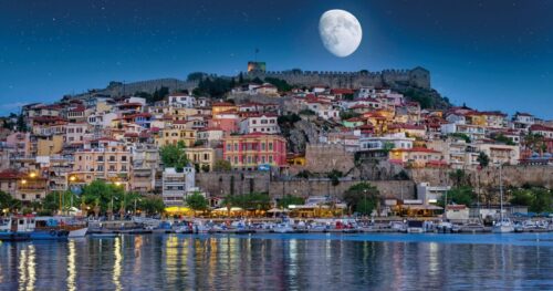 Kavala harbor with Byzantine Kamares aqueduct and traditional fishing boats at golden hour — MTG Travel transfers